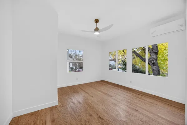 wooden floor in an empty room with a window