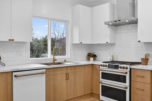a kitchen with a sink stove and cabinets