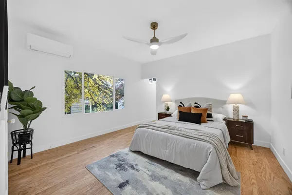 a bedroom with a bed and a potted plant