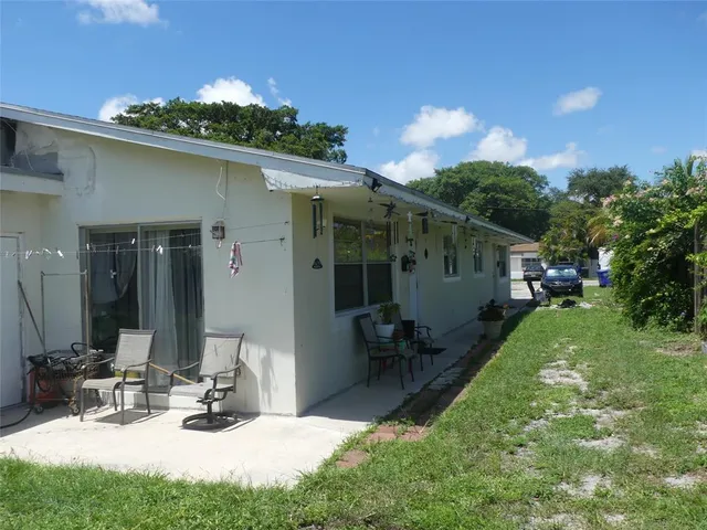a view of house with backyard outdoor seating and green space
