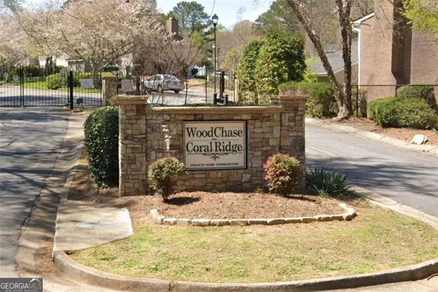 a view of a swimming pool with a bench and trees