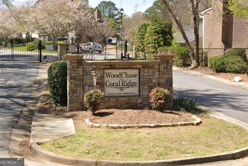 1166 Booth Road, Unit 903 Marietta, GA 30008 - Photo 12 of 15 a view of a swimming pool with a bench and trees