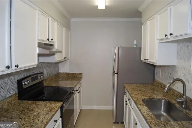a kitchen with stainless steel appliances granite countertop a sink stove and refrigerator