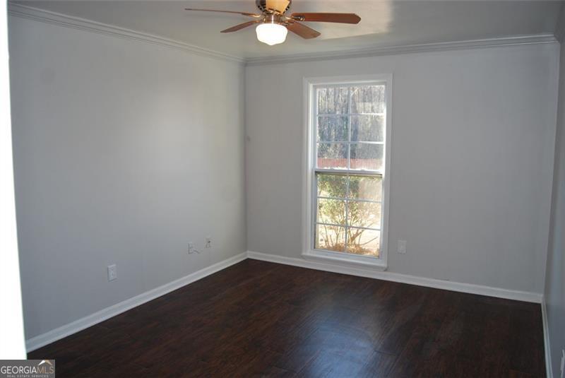 1166 Booth Road, Unit 903 Marietta, GA 30008 - Photo 7 of 15 an empty room with wooden floor and windows