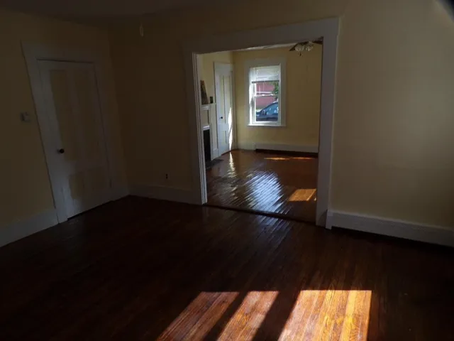 a view of an empty room and wooden floor