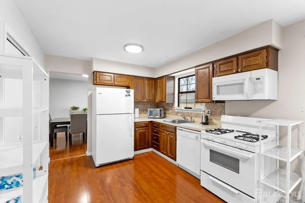 a kitchen with a stove a sink and a refrigerator