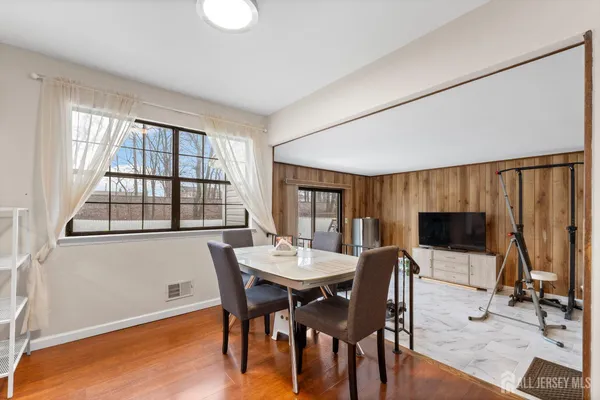 a view of a dining room with furniture and a flat screen tv