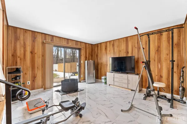 a view of a livingroom with furniture and a flat screen tv