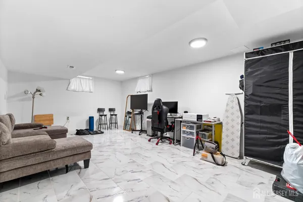 a living room with furniture gym equipment and a flat screen tv