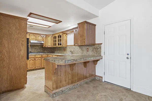 a kitchen with stainless steel appliances granite countertop a sink and cabinets