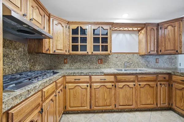 a kitchen with stainless steel appliances granite countertop a sink and cabinets