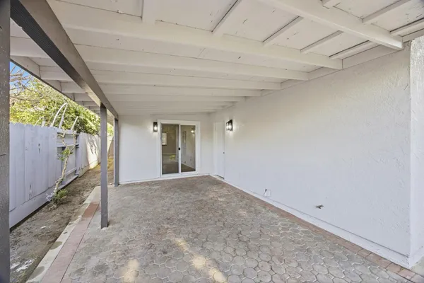 a view of empty room with floor to ceiling window and stairs