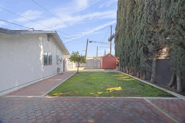 a backyard of a house with table and chairs