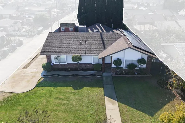 a aerial view of a house with a yard