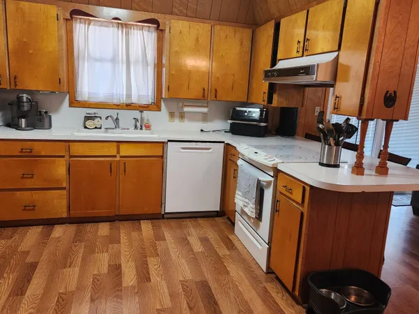 a kitchen with stainless steel appliances granite countertop a sink stove and cabinets