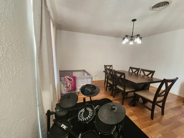 a view of a dining room with furniture and wooden floor