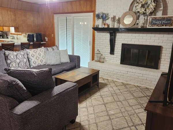 a living room with furniture and a fireplace
