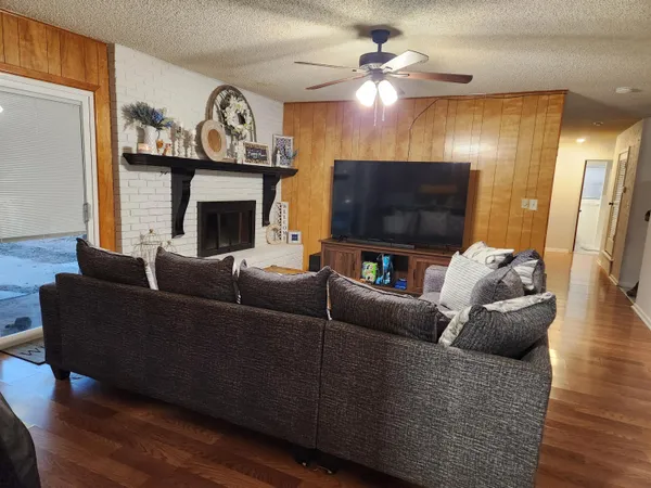 a living room with furniture a flat screen tv and a fireplace