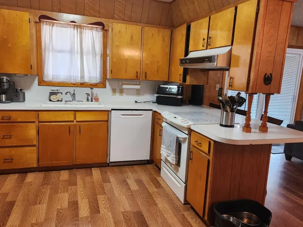 a kitchen with stainless steel appliances granite countertop a sink stove and cabinets