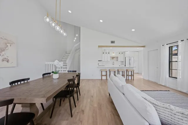 a dining room with furniture and wooden floor