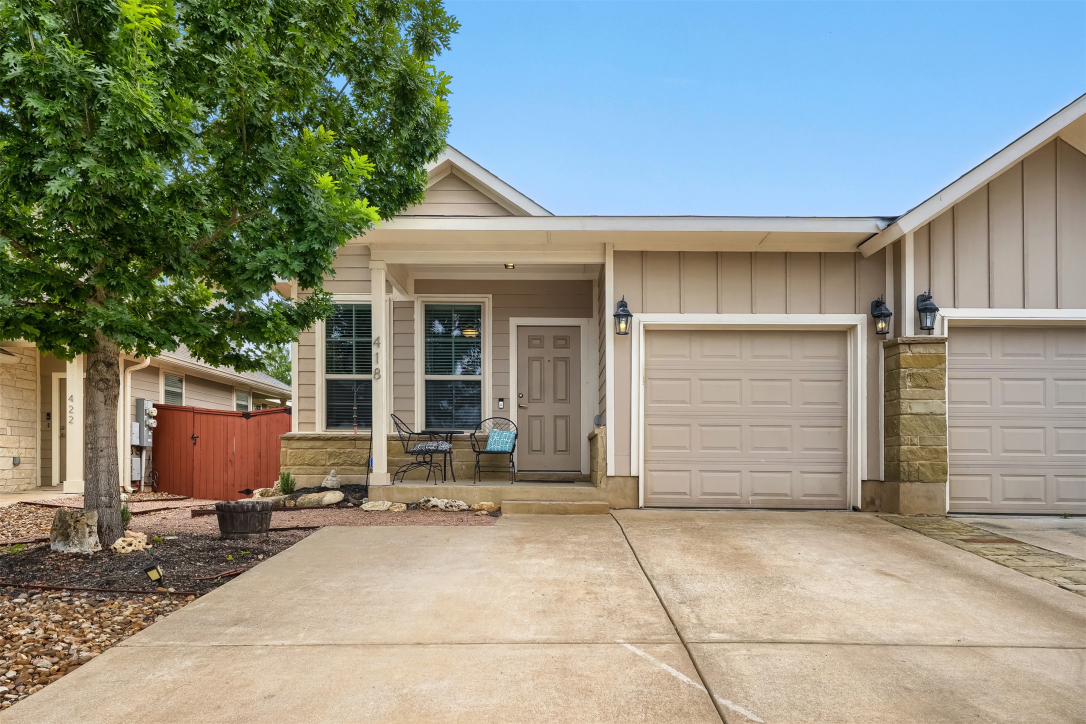 418 High Tech Drive Georgetown, TX 78626 - Photo 1 of 34 Warm exterior with neutral siding and stone accents, featuring a covered front porch, an attached garage, and concrete driveway