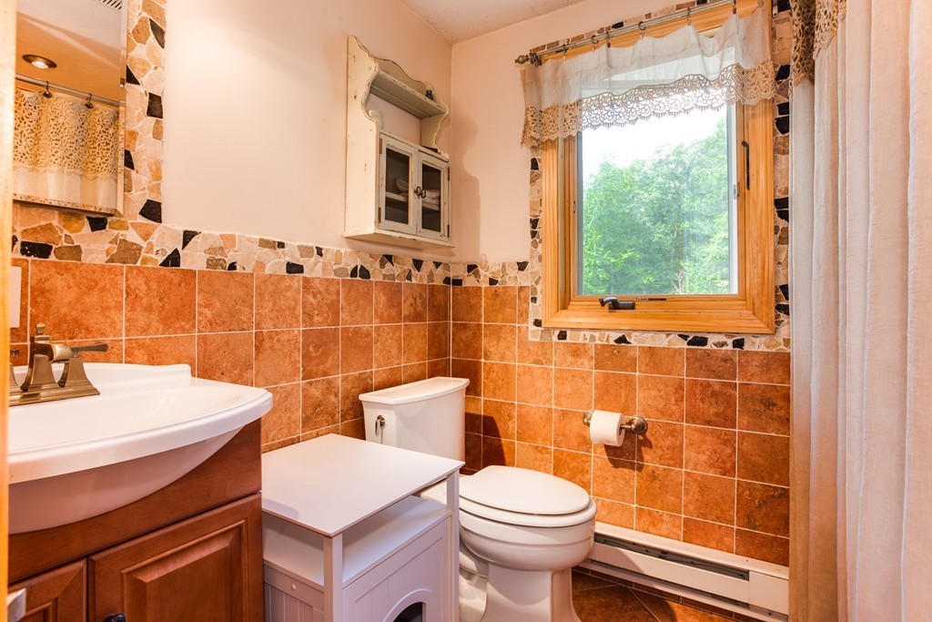 28 Lincoln Point Road Charlton, MA 01507 - Photo 17 of 26 a bathroom with a sink toilet and shower