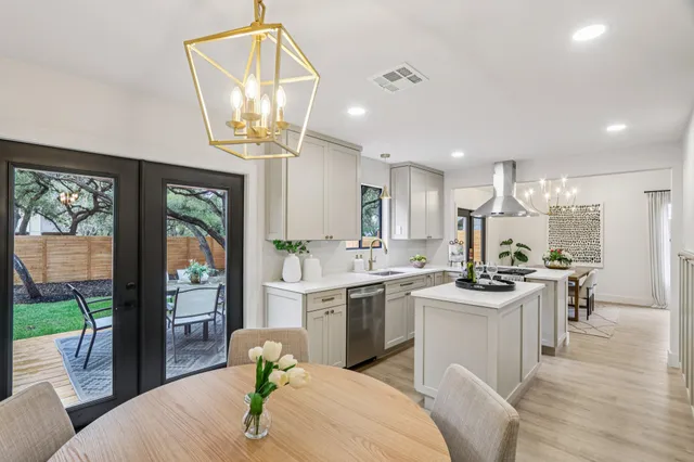 a bathroom with double vanity sinks and a mirror