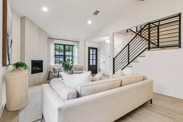 a living room with furniture and a potted plant