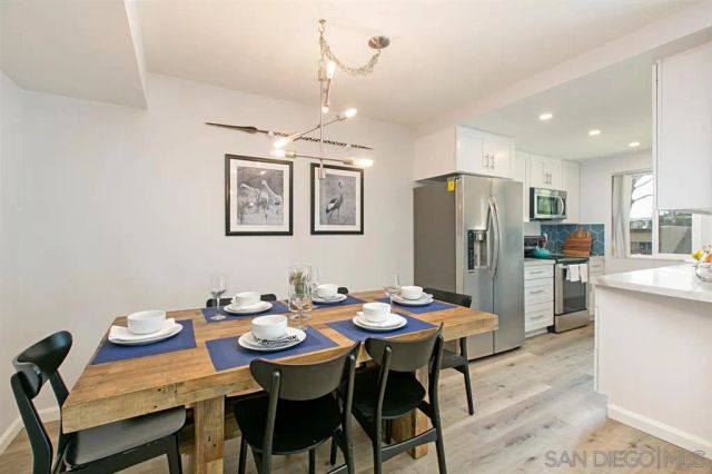 a dining room with a table chairs and refrigerator