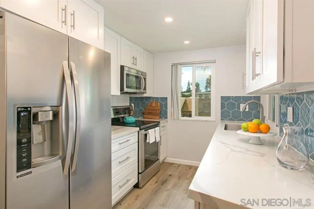 a kitchen with stainless steel appliances a refrigerator and a sink
