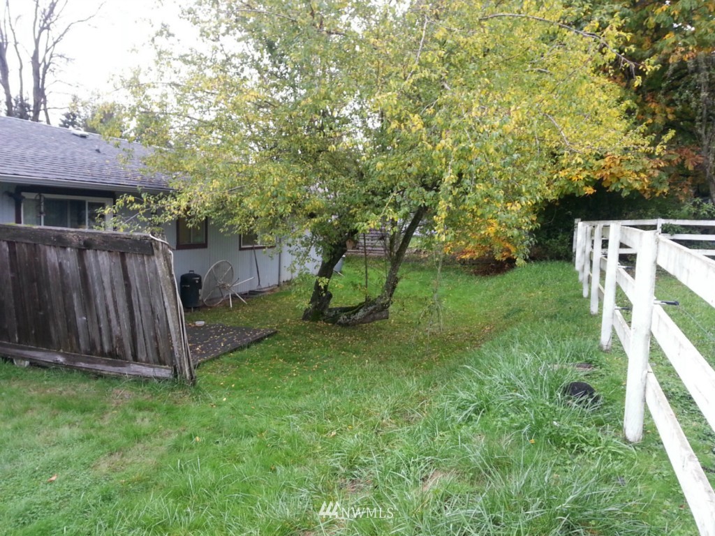 10415 Golden Given Road East Tacoma, WA 98445 - Photo 12 of 14 a view of a backyard with wooden fence and large trees