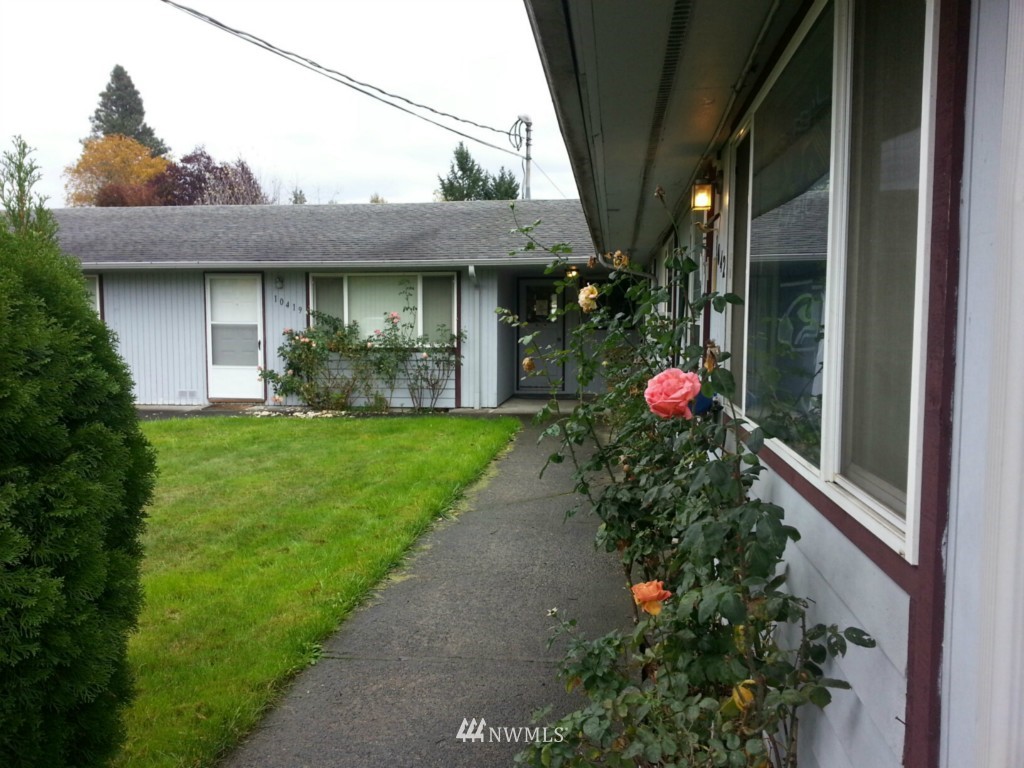 10415 Golden Given Road East Tacoma, WA 98445 - Photo 14 of 14 a front view of a house with a yard and potted plants