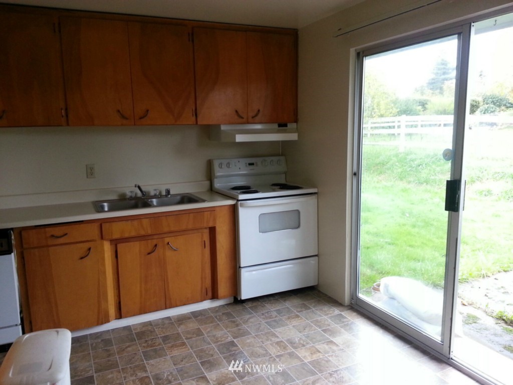 10415 Golden Given Road East Tacoma, WA 98445 - Photo 6 of 14 a kitchen with a stove sink and cabinets