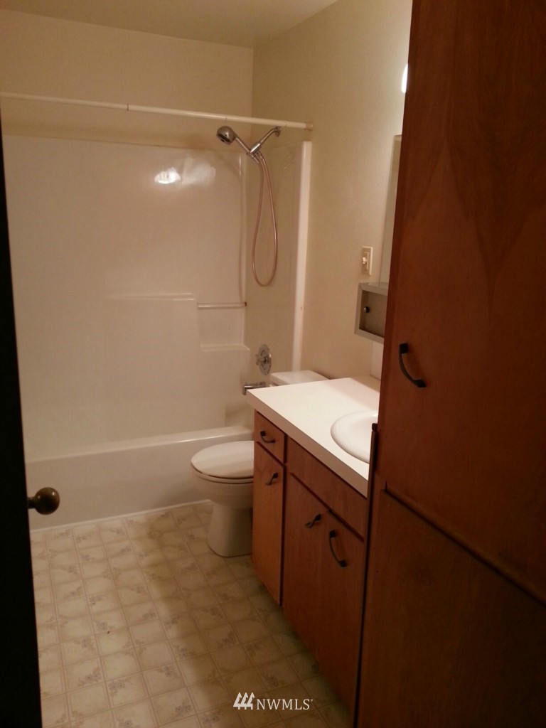 10415 Golden Given Road East Tacoma, WA 98445 - Photo 9 of 14 a bathroom with a granite countertop sink toilet and shower