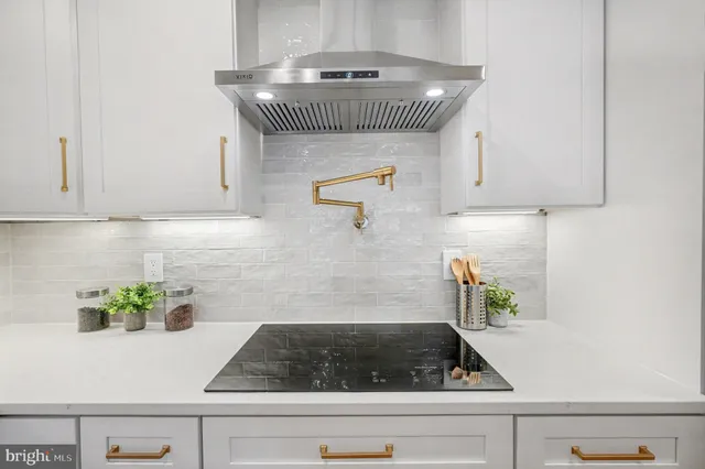 a living room with stainless steel appliances kitchen island granite countertop furniture and a kitchen view
