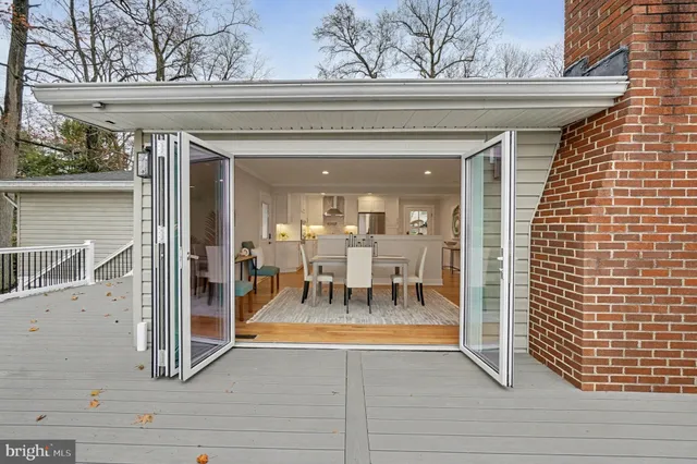 a living room with furniture a wooden floor and a potted plant