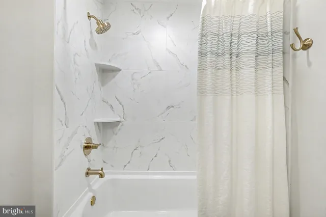 a living room with furniture a table and a potted plant
