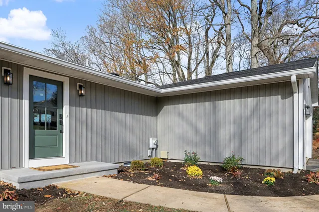 a kitchen with stainless steel appliances granite countertop a sink and a refrigerator