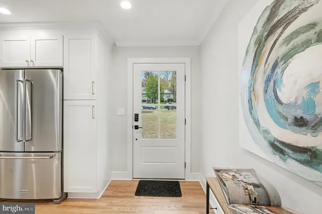 a kitchen with stainless steel appliances granite countertop a stove top oven a sink and a refrigerator