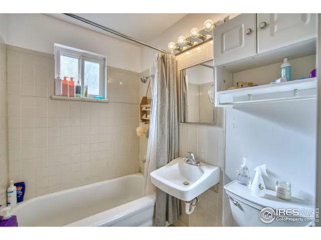 a bathroom with a sink a mirror and a bathtub