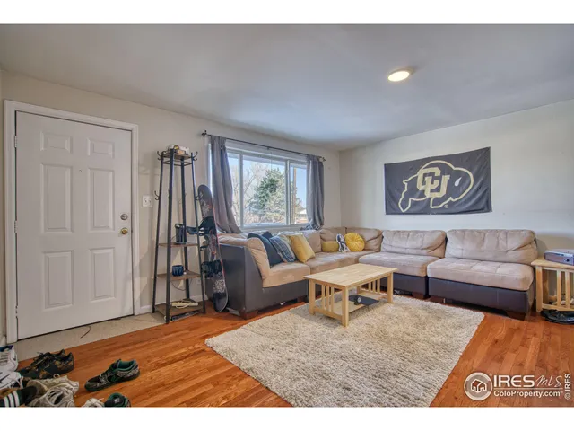 a living room with furniture window and a wooden floor