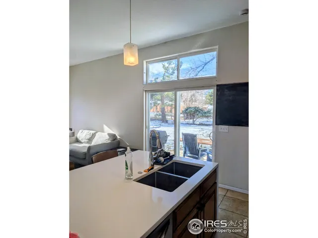 a kitchen with a sink and large window