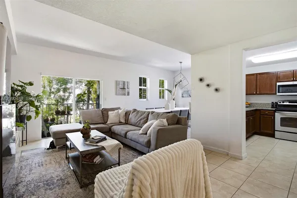 a living room with furniture and a kitchen