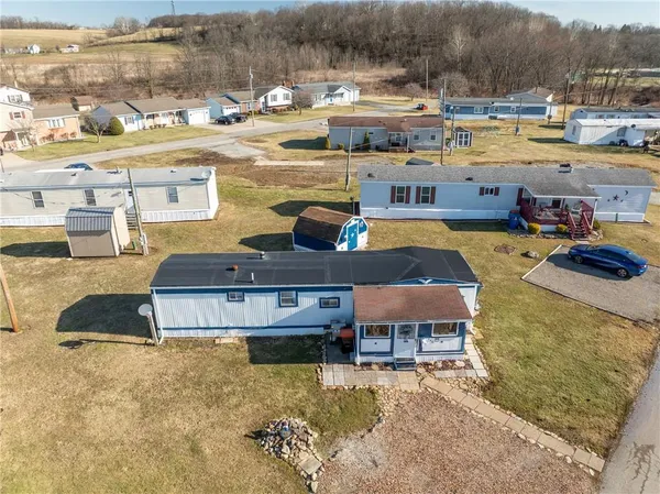 an aerial view of a houses with a city view
