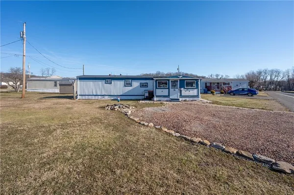 a view of a house with a yard and sitting area