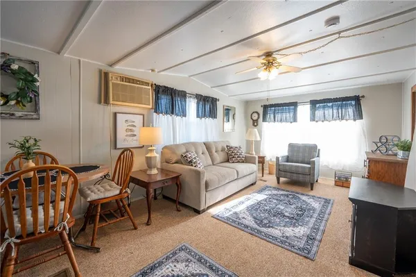 a living room with furniture a rug and a chandelier