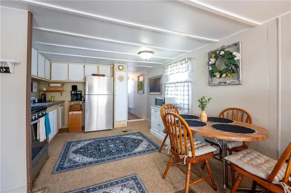 a view of a dining room with furniture and a rug