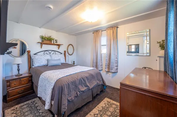 a bedroom with bed and wooden floor