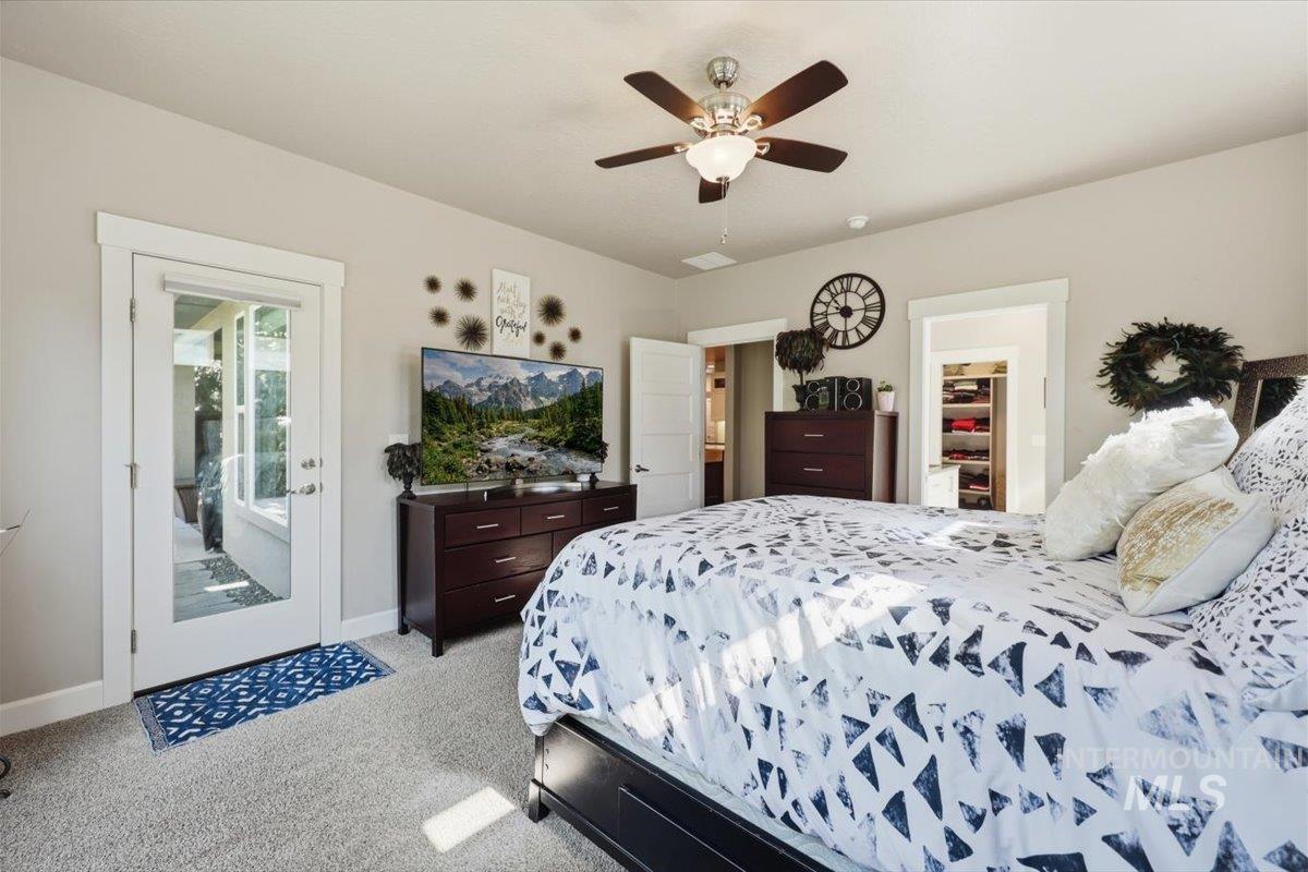 1303 West Brando Street Meridian, ID 83646 - Photo 23 of 49 Plush carpet flooring, a ceiling fan with integrated lighting, and a glass-paneled door opening to an outdoor area
