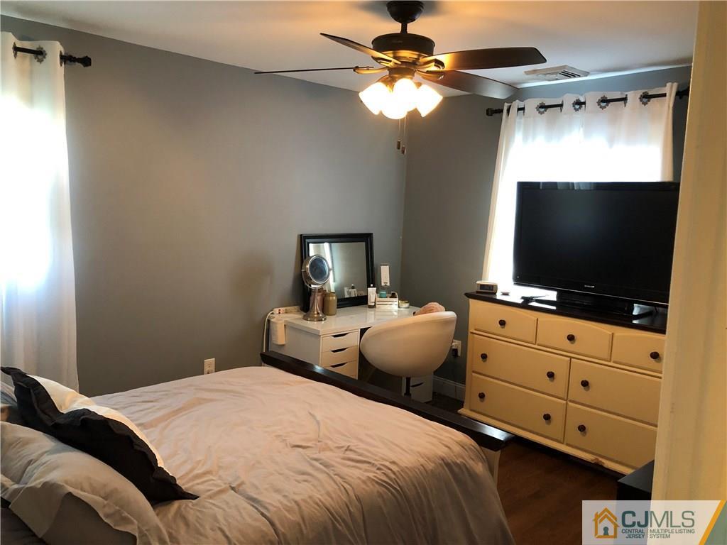 13 Phillips Road Edison, NJ 08817 - Photo 12 of 25 a bedroom with a bed and a flat screen tv